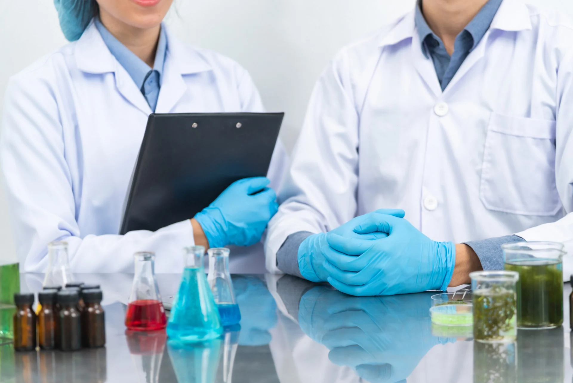 Two scientists in a laboratory reviews data, representing PicoTeam’s digital solutions for animal research facilities.