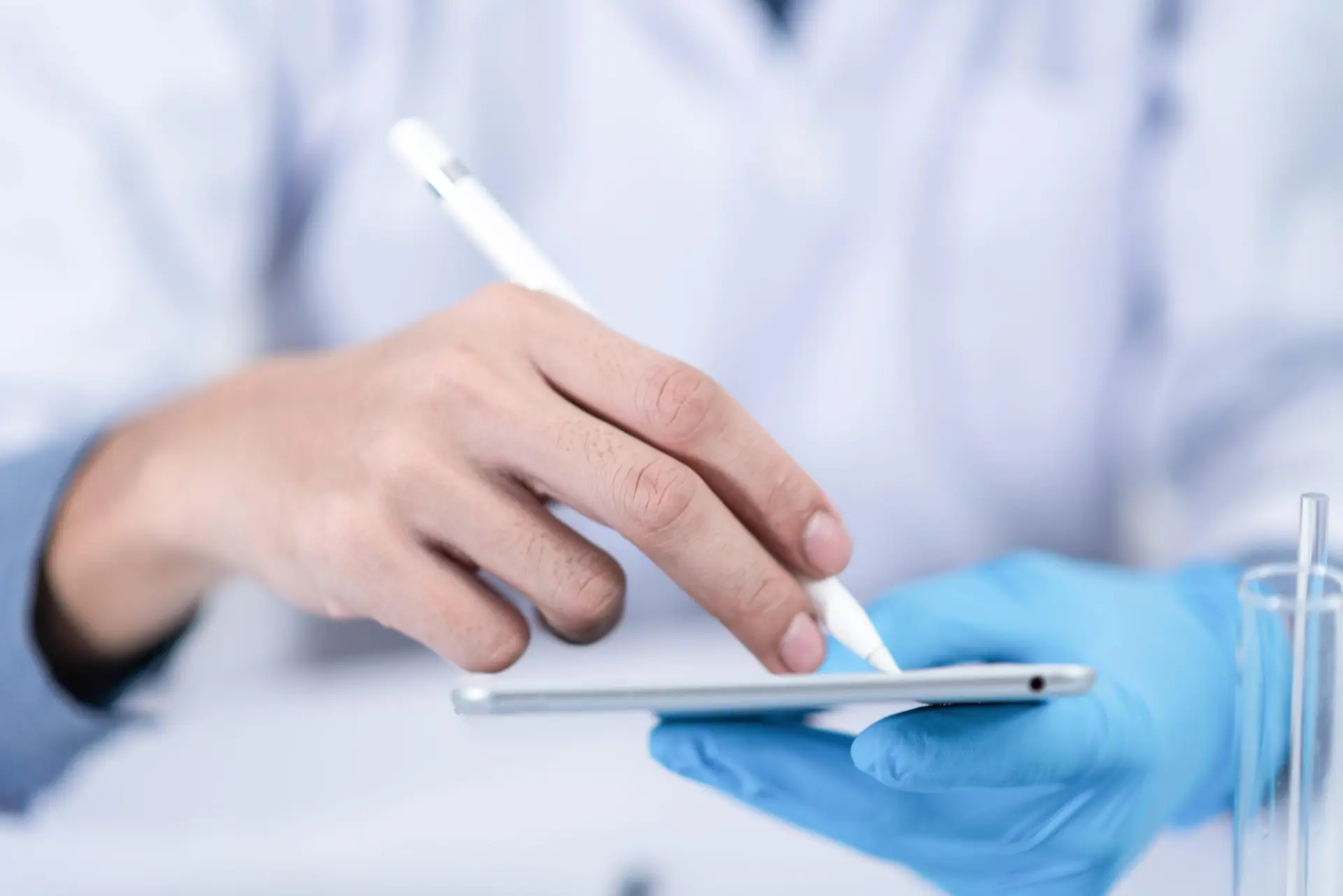 Scientist using a digital tablet with stylus in a laboratory, symbolizing PicoTeam’s digital traceability solution for animal by-products and derived products.